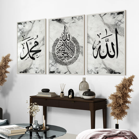 A set of three framed Islamic wall art prints featuring black and white marble-like frames with Arabic calligraphy of Allah, Ayatul Kursi, and Muhammad, displayed above a modern desk.