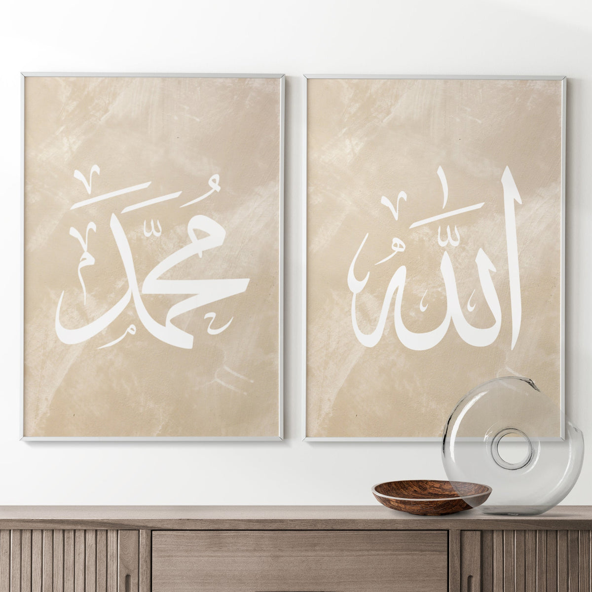 Two framed pieces of art with Arabic calligraphy on a wall above a wooden console table.