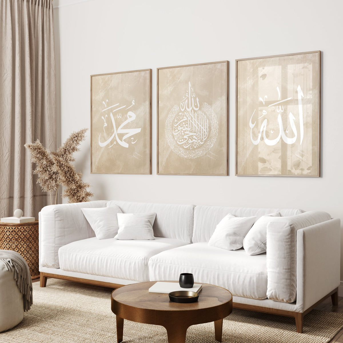 Living room with a white sofa, wooden coffee table, and three framed Arabic calligraphy pieces on the wall.