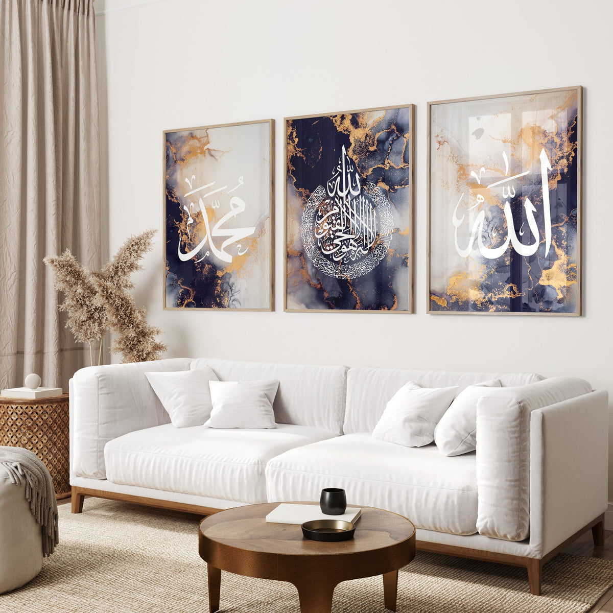 Living room with a white sofa, wooden coffee table, and three framed artworks on the wall.
