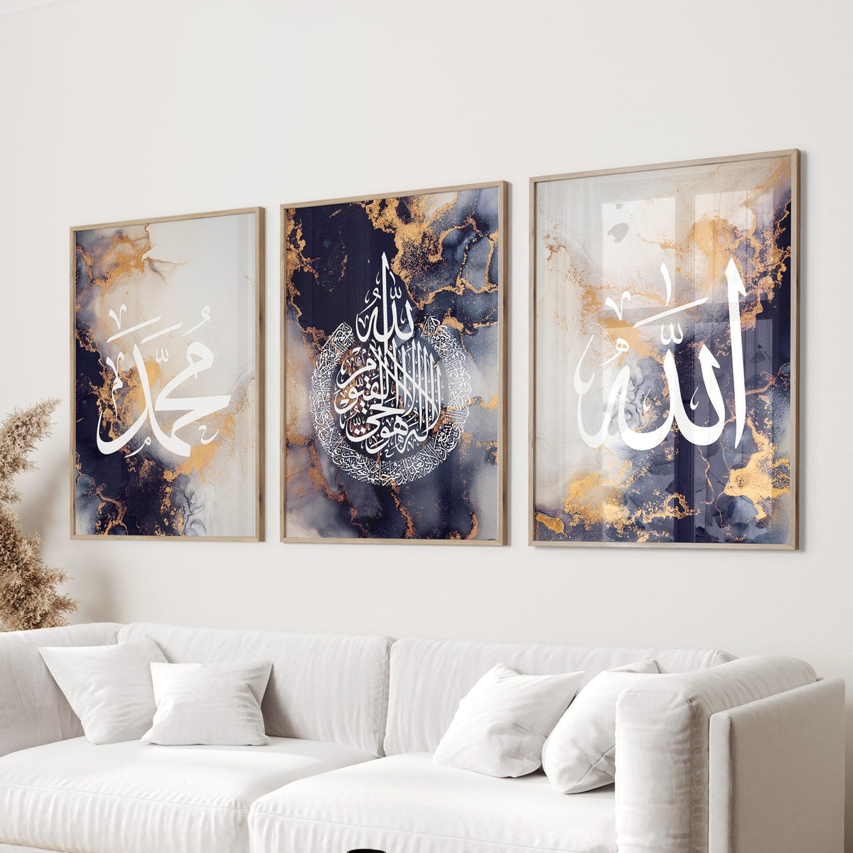 A set of three navy blue and gold liquid marble frame wall art prints featuring Arabic calligraphy of Allah, Ayatul Kursi, and Muhammad, displayed in a living room setting.