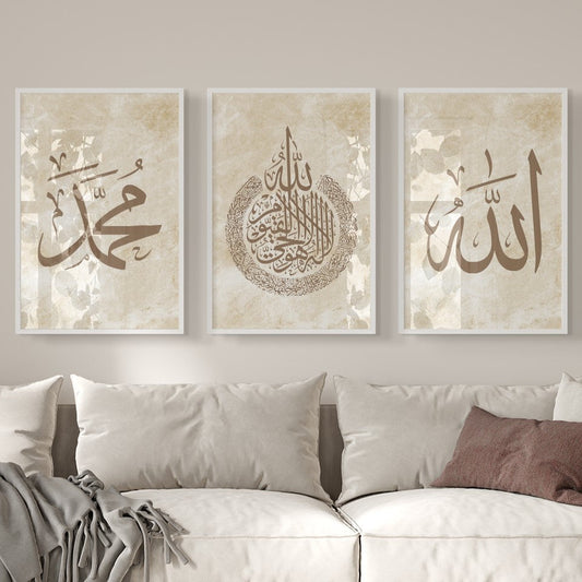 Three framed pieces of art with Arabic calligraphy above a white sofa.