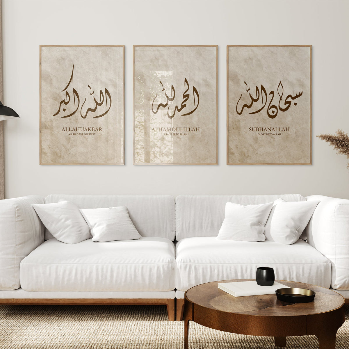 White sofa in a living room with three framed artworks on the wall.
