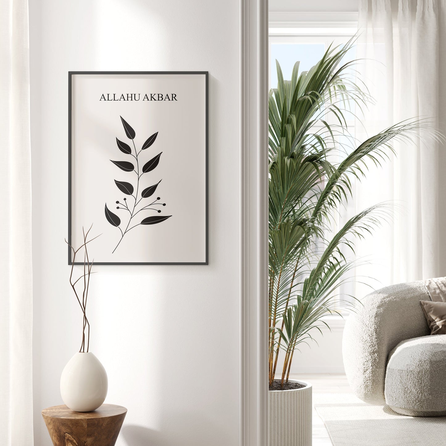 Framed artwork with 'ALLAHU AKBAR' text and leaf design in a modern interior setting.