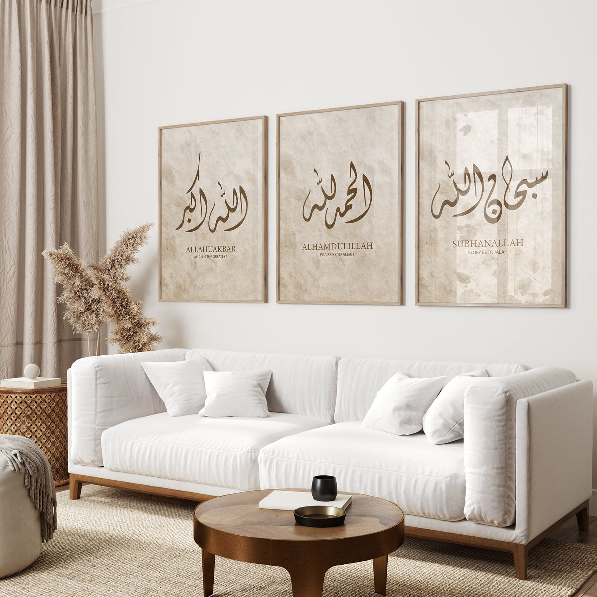 Living room with a white sofa, wooden coffee table, and three framed Arabic calligraphy artworks on the wall.