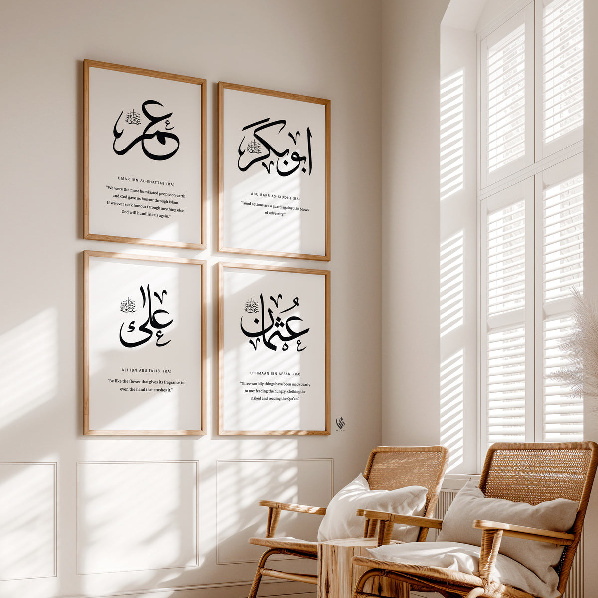 Set of four Islamic wall art prints Arabic calligraphy Abu Bakr Umar Uthman Ali on a wall with natural light coming through windows.
