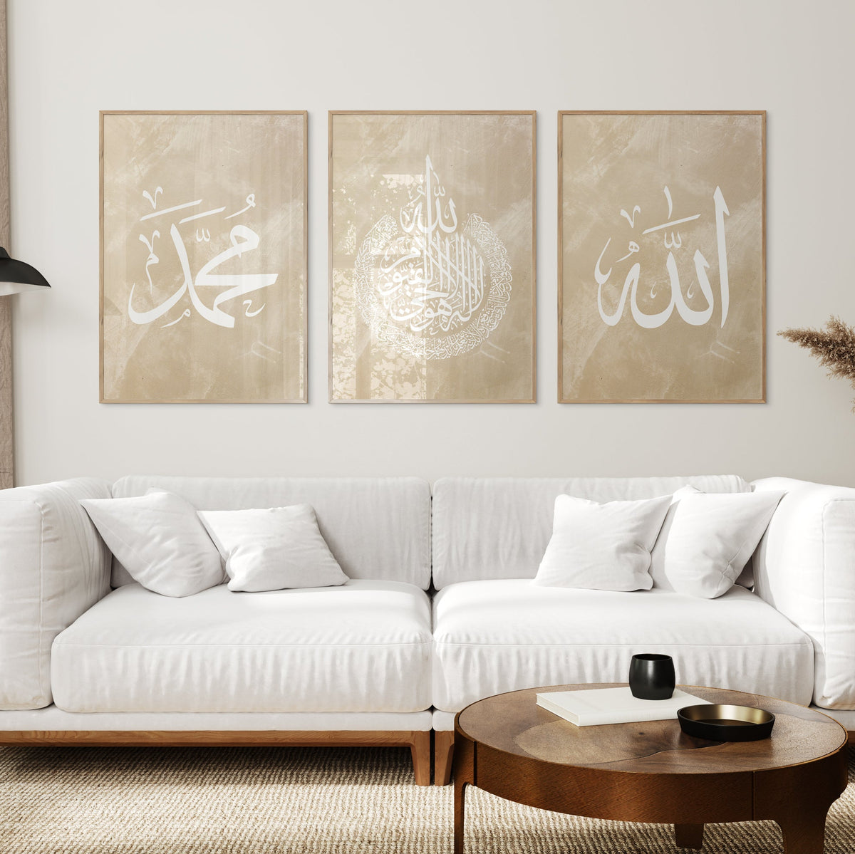 Living room with a white sofa, coffee table, and wall art featuring Arabic calligraphy.