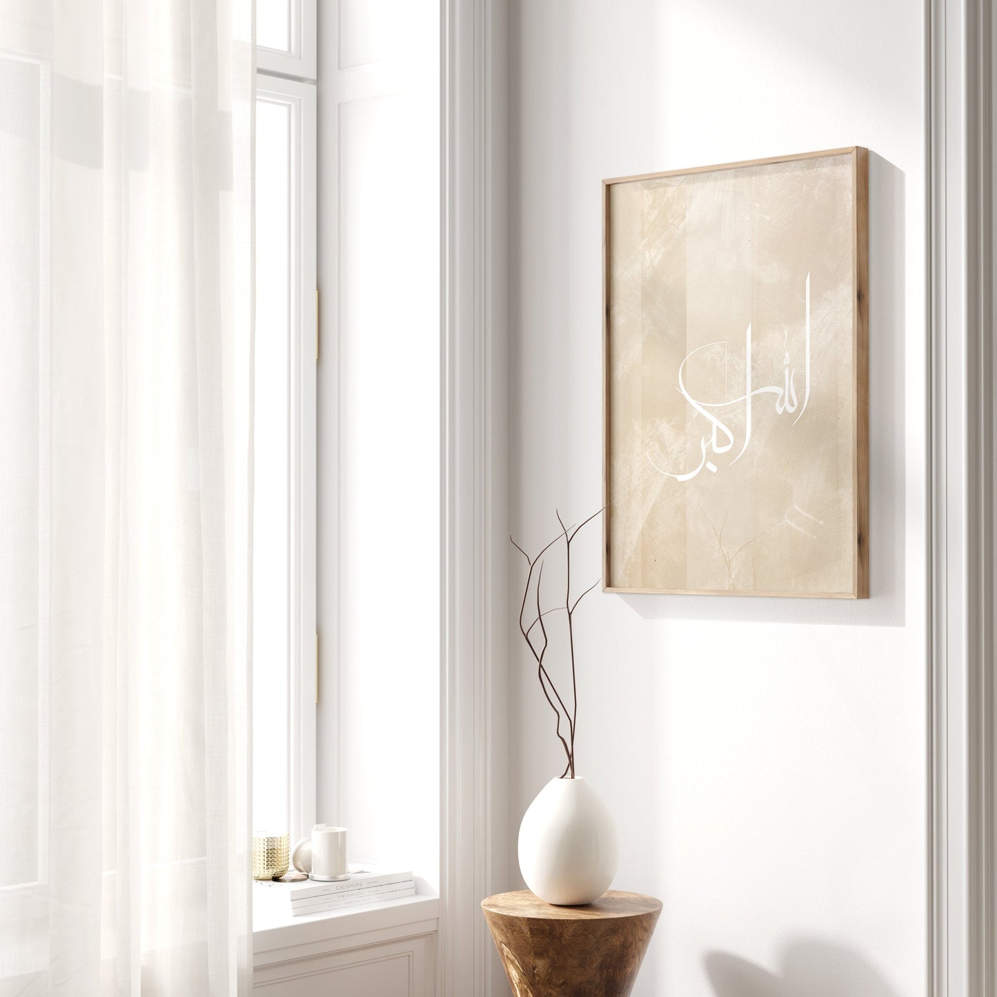 Beige framed artwork on a white wall with a window and wooden stool in the foreground