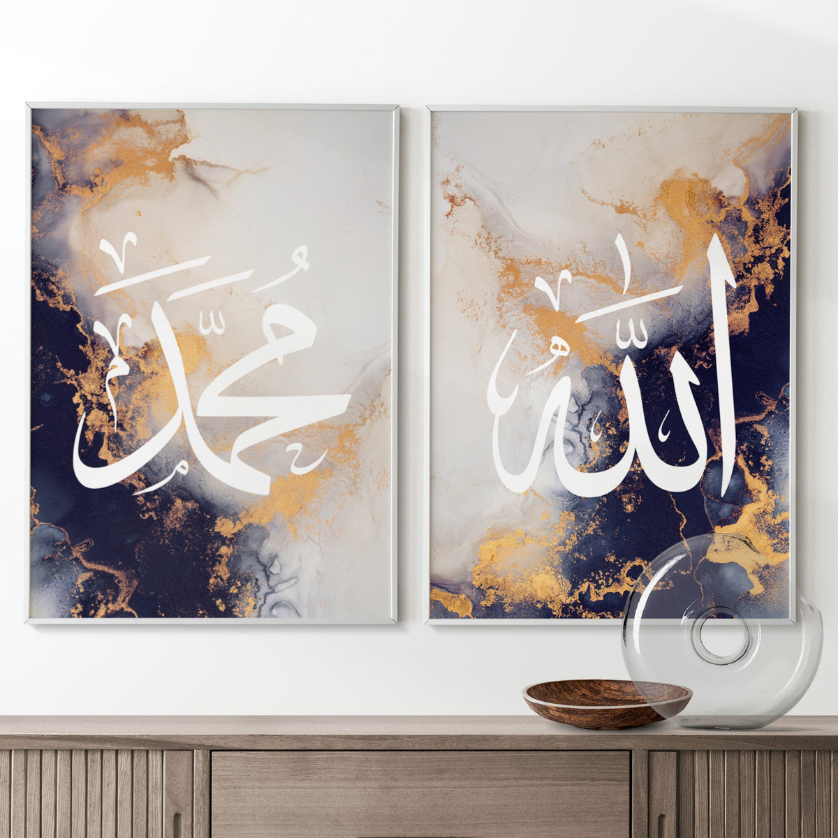 Two abstract art pieces with calligraphy on a wall above a wooden console table.