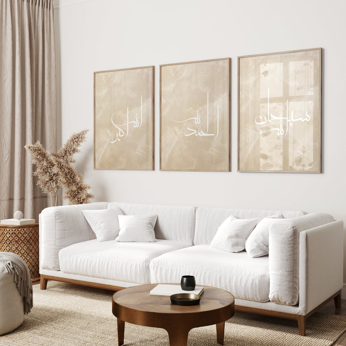 Living room with a white sofa, wooden coffee table, and three framed artworks on the wall.