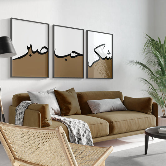 Living room with a brown sofa, wicker chair, and wall art