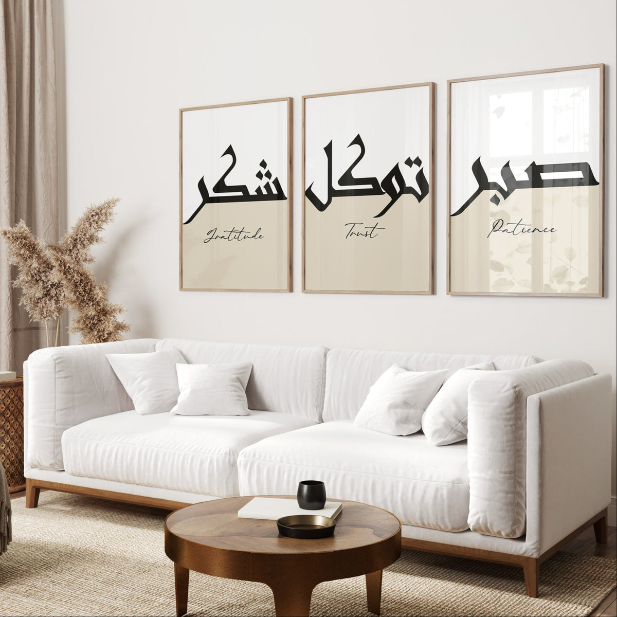 Living room with a white sofa, wooden coffee table, and wall art with Arabic text.