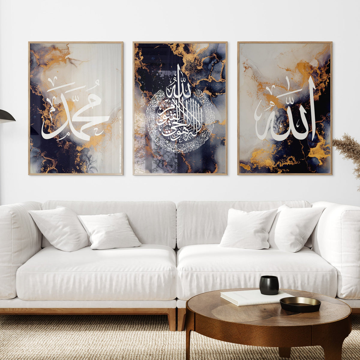 White sofa with decorative pillows in a living room setting with three framed artworks on the wall.