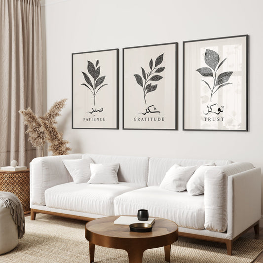 Living room with a white sofa, wooden coffee table, and wall art with leaf designs and text.