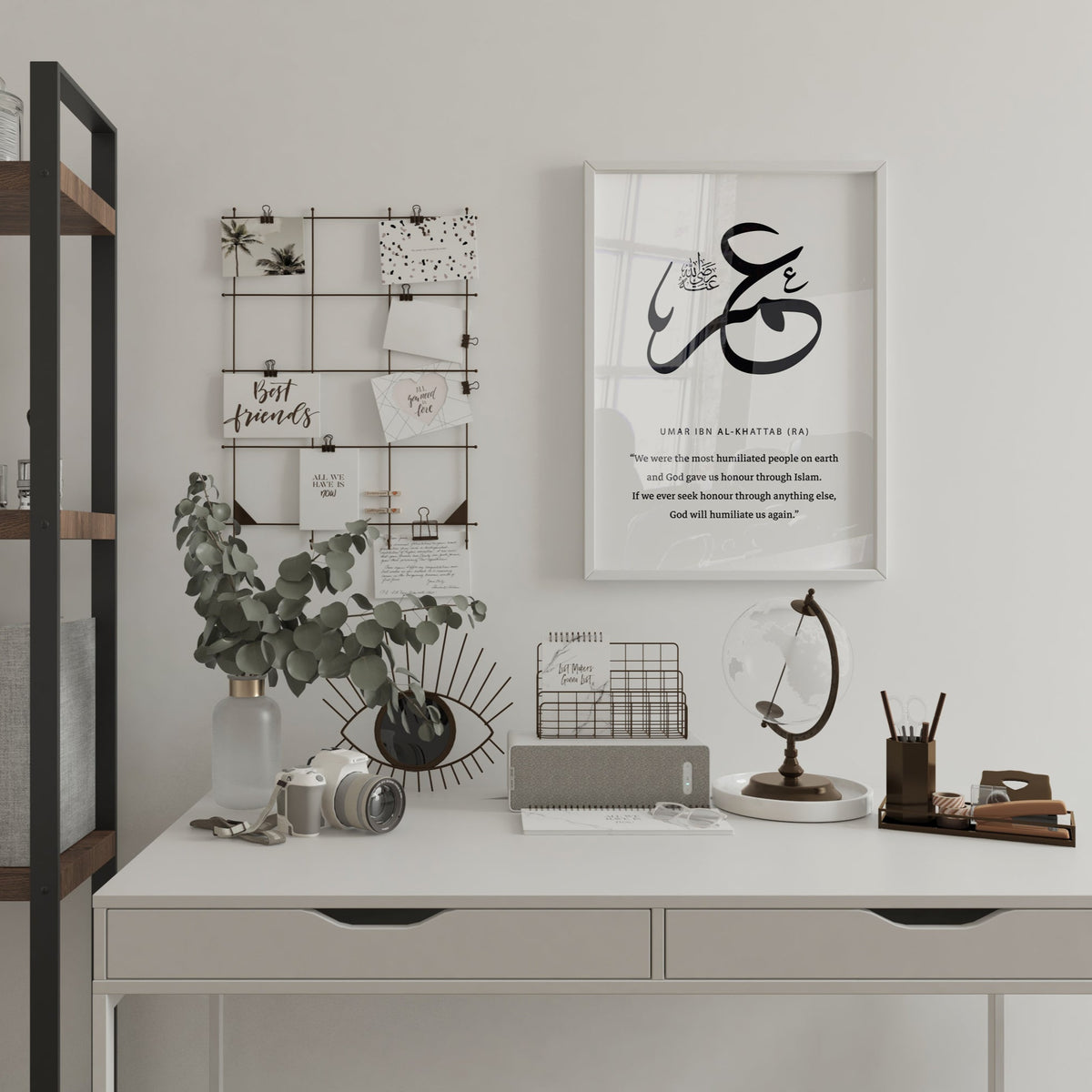 Modern office desk with decorative items and framed artwork on a wall.