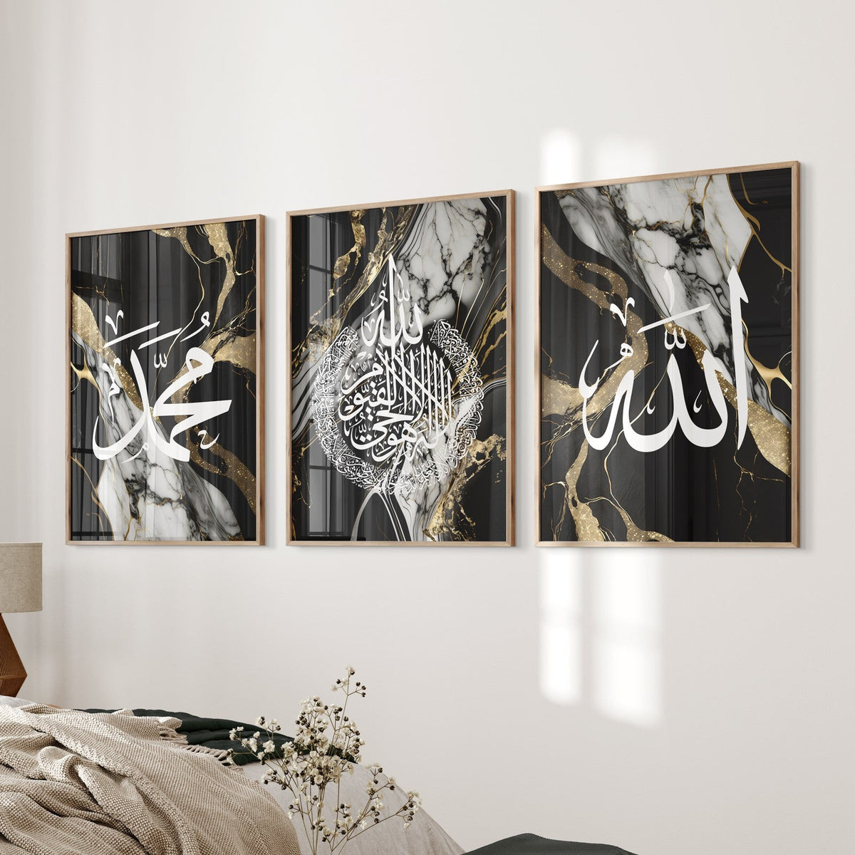 A set of three framed wall art prints with black and gold marble liquid texture, featuring Arabic calligraphy, displayed in a home setting.