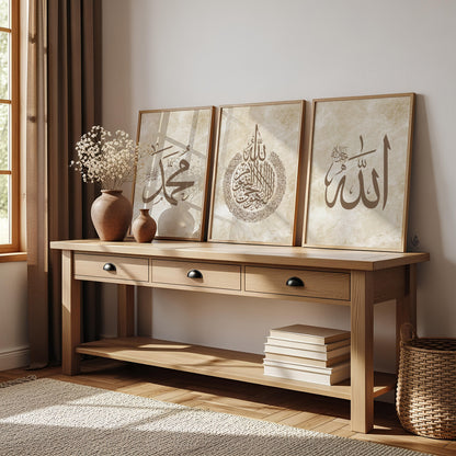 Wooden console table with decorative items in a room with a window and rug. Allah print in bold Thuluth script on a cream marble background, part of a coordinated art set.