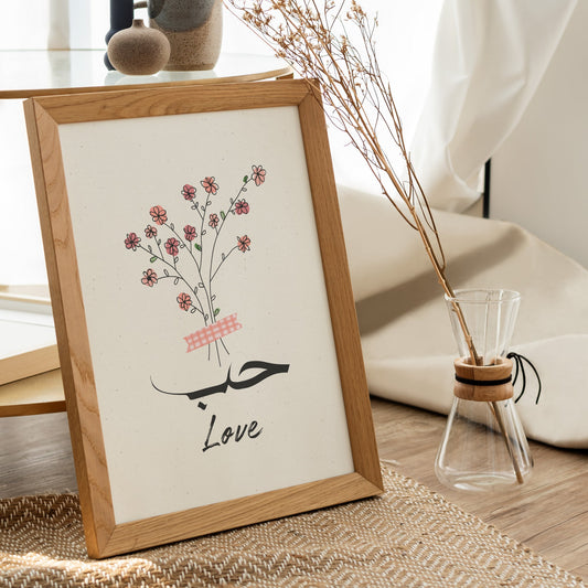 Framed artwork with floral design and 'Love' text on a table.