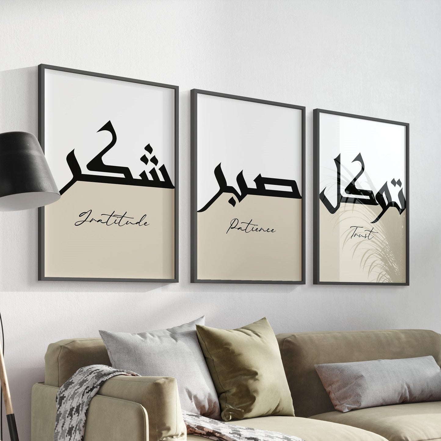 A set of three framed Islamic art prints with Arabic calligraphy hanging on a wall over a sofa, depicting the words 'Patience', 'Gratitude', and 'Trust' in Arabic script.