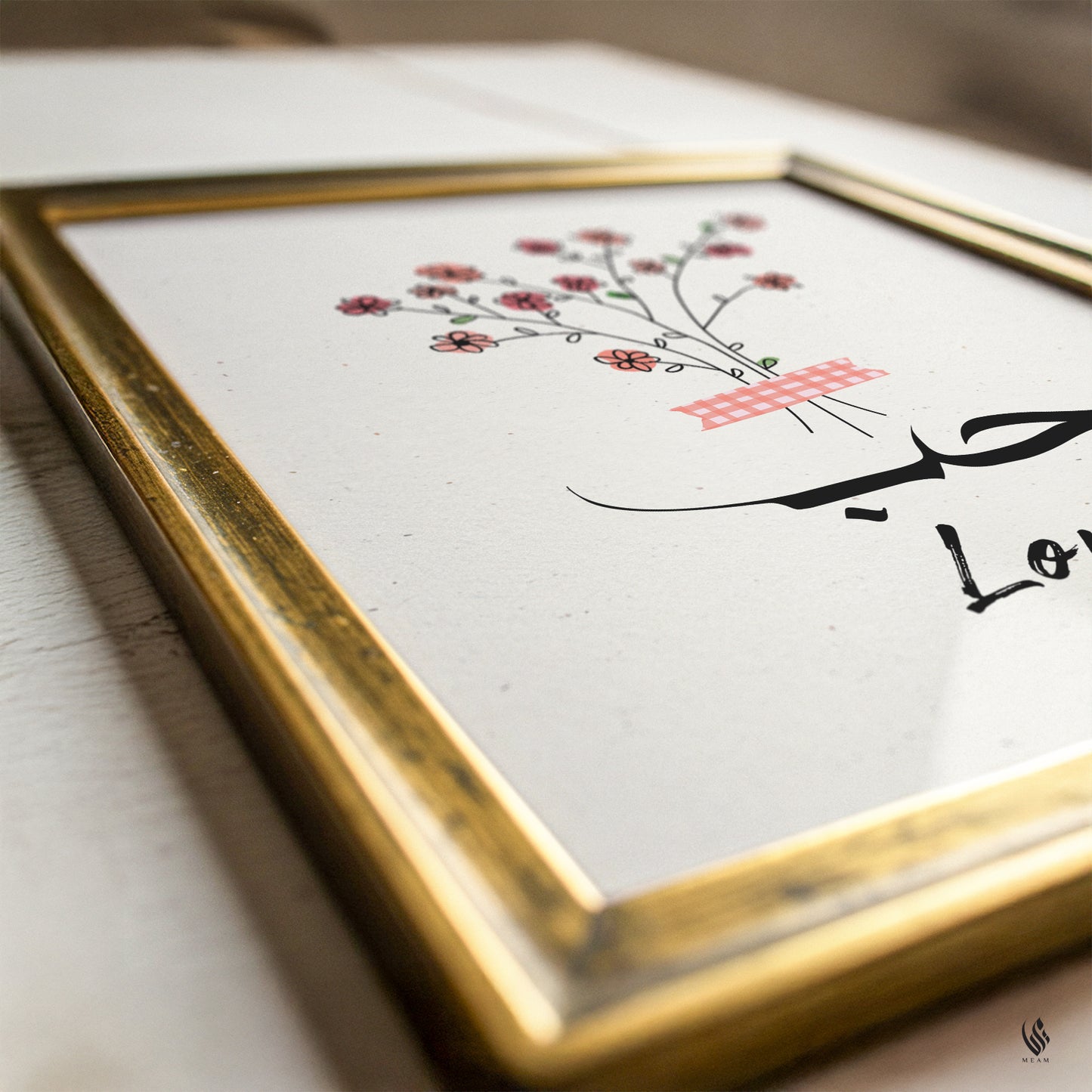 Framed artwork with floral design and text on a white surface