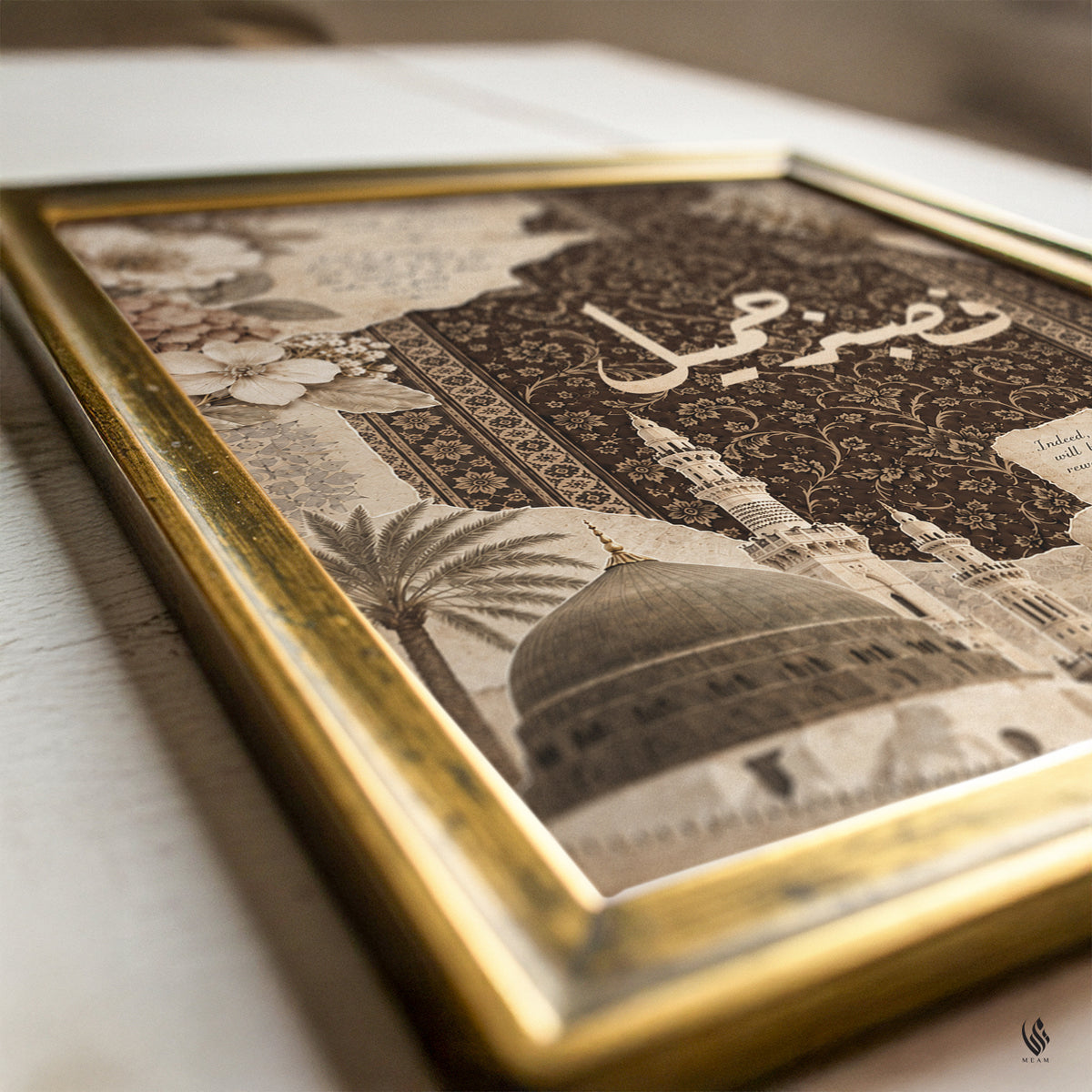 A framed art print featuring a sepia-toned illustration of a domed mosque with Arabic calligraphy and ornate patterns, set in a distressed gold frame on a light wooden surface.