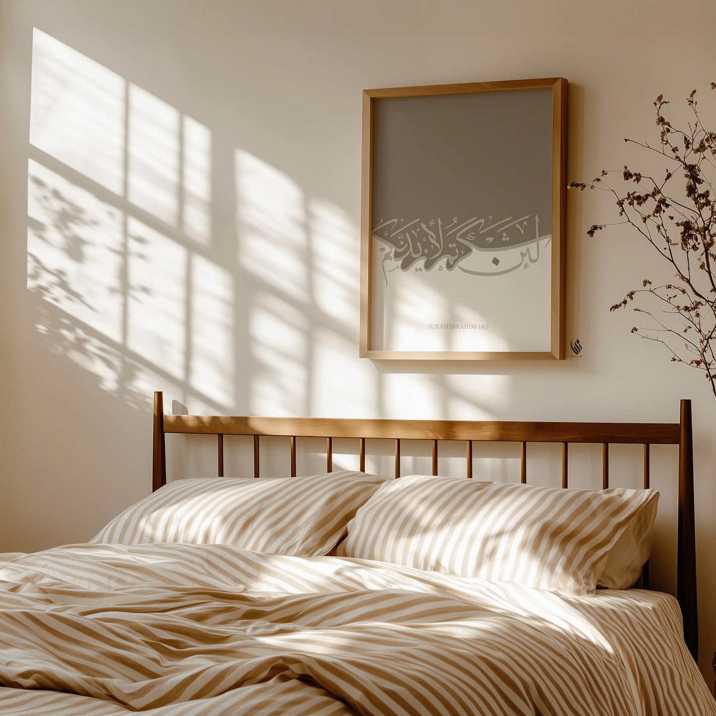 Bedroom with wooden headboard, striped bedding, and framed artwork on the wall. La'in shakartum Quran print displayed above a bed, soft beige tones against a white wall