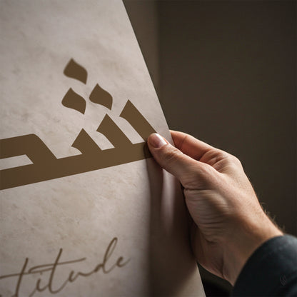 Hand holding a decorative cutout against a textured surface with 'Attitude' text.