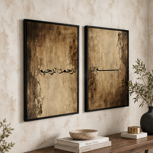 Pair of Bismillahir Rahmanir Raheem Islamic wall art prints hung side by side in black frames above a walnut console. Black Arabic calligraphy spans both brown and beige designs, with stone-like marks, cracks and dark edges. Textured cream wall, books, ceramic bowl and black vase complete the scene.