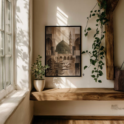 Madina mosque wall art in a black frame above a rustic wooden bench, surrounded by green plants and window light.