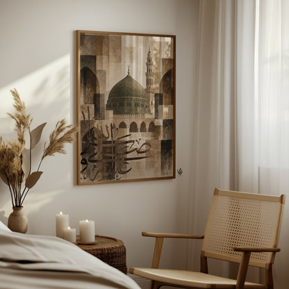 Madina mosque Islamic wall art in a natural wood frame beside a woven chair in a softly lit neutral interior.