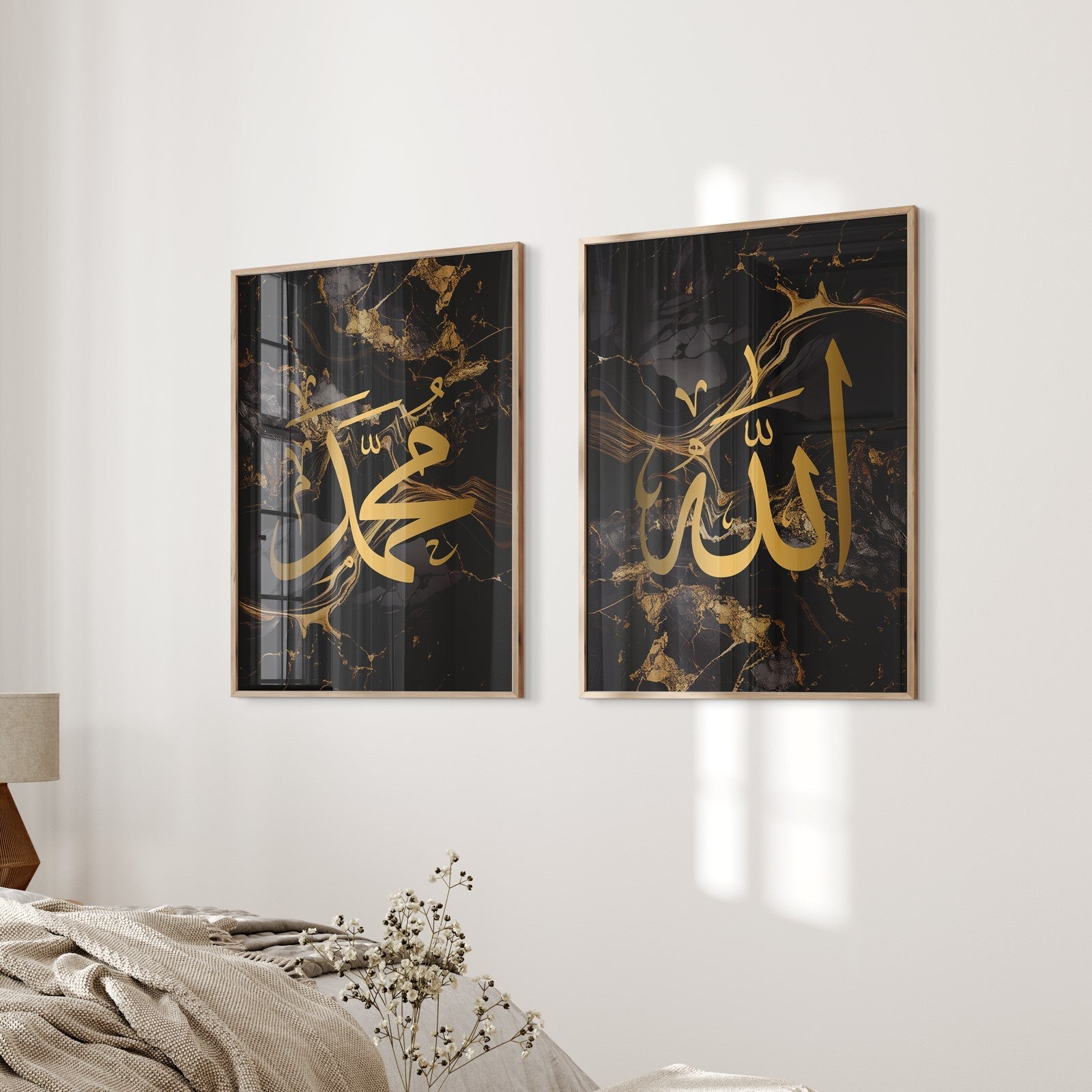 Two framed pieces of art with gold calligraphy on a wall in a living room.
