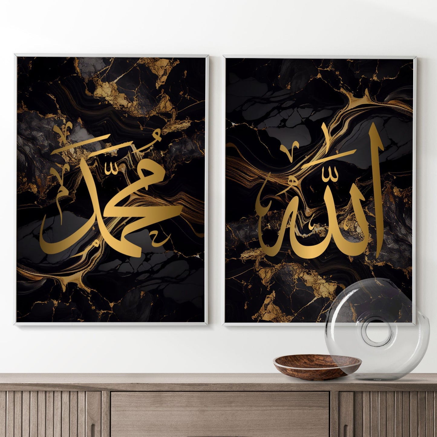 Two Black & Gold Arabic Calligraphy Islamic wall art prints with Allah and Muhammad in Arabic calligraphy thuluth in gold on top of a brown ikea besta draw in a living room.